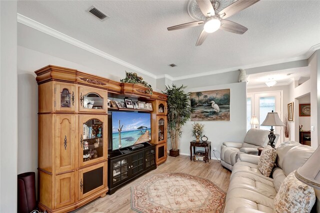 living room featuring a textured ceiling, light hardwood / wood-style floors, ceiling fan, and crown molding