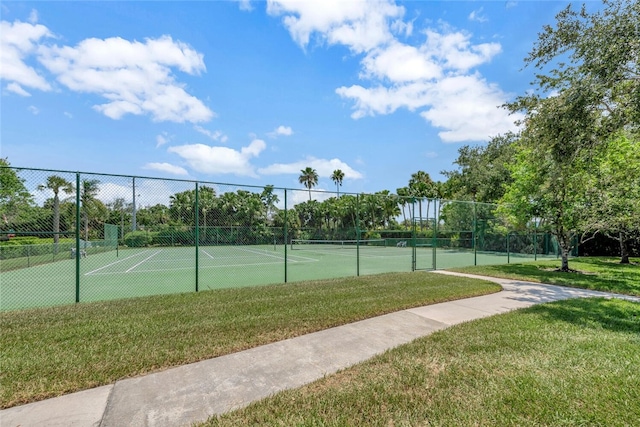 view of sport court with a lawn