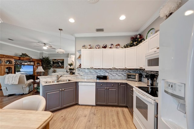 kitchen featuring white cabinetry, sink, decorative light fixtures, white appliances, and gray cabinets