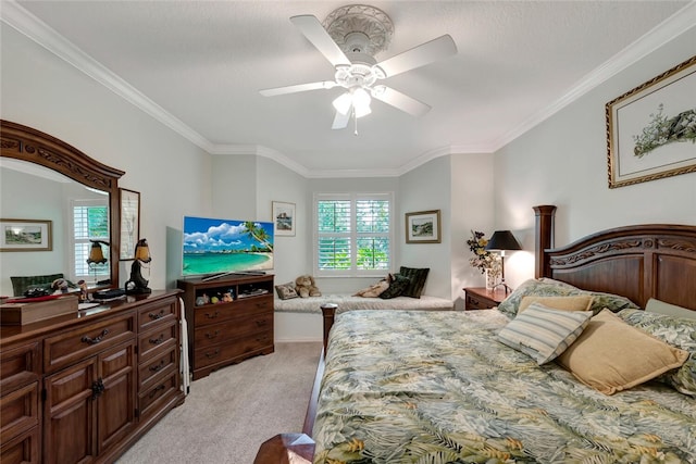 carpeted bedroom featuring ceiling fan and crown molding