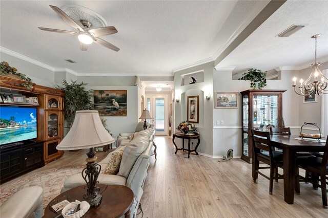 living room featuring a textured ceiling, ceiling fan with notable chandelier, crown molding, and light hardwood / wood-style flooring