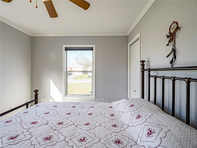 unfurnished bedroom with ceiling fan, a closet, and ornamental molding