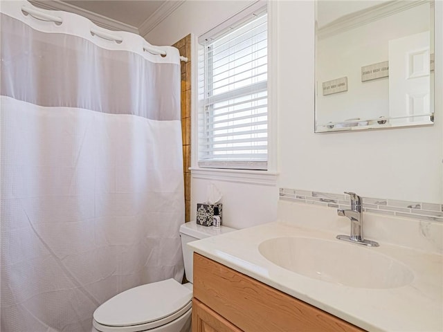 bathroom featuring toilet, crown molding, and vanity