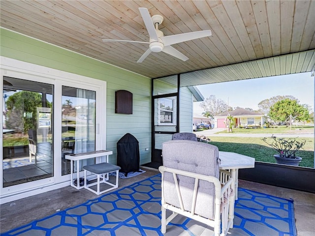 sunroom / solarium featuring ceiling fan, wood ceiling, and lofted ceiling