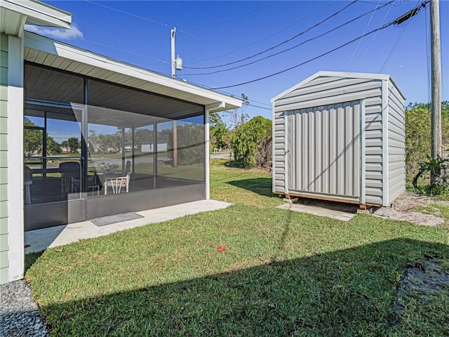 view of yard featuring a sunroom and a storage shed