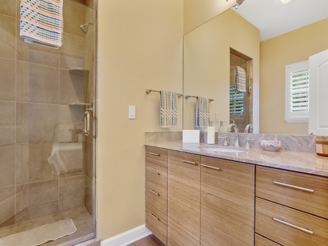 bathroom featuring vanity and a shower with door