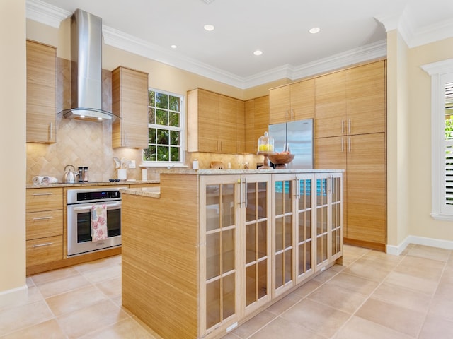 kitchen featuring ornamental molding, stainless steel appliances, wall chimney exhaust hood, and light tile patterned floors