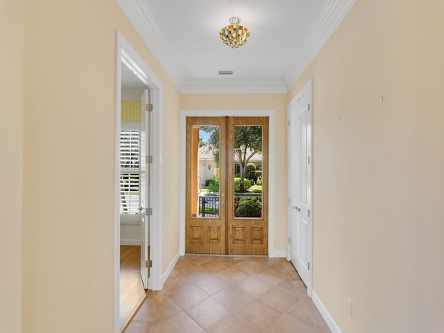 foyer featuring light wood-type flooring and crown molding