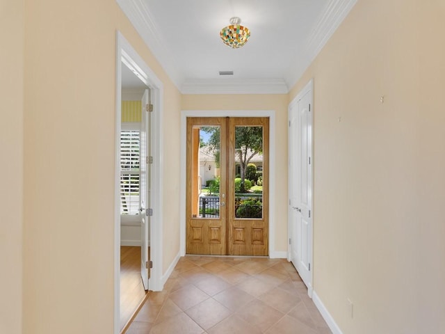 9082 Castle Harbour Cir, Vero Beach, FL 32963 - doorway featuring ornamental molding, baseboards, and light tile patterned flooring