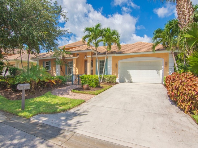 9082 Castle Harbour Cir, Vero Beach, FL 32963 - view of front of house with stucco siding, an attached garage, concrete driveway, a tiled roof, and fence