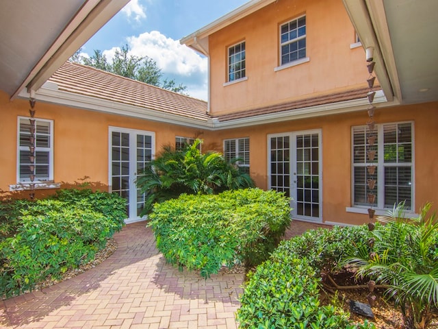 9082 Castle Harbour Cir, Vero Beach, FL 32963 - property entrance with stucco siding and french doors