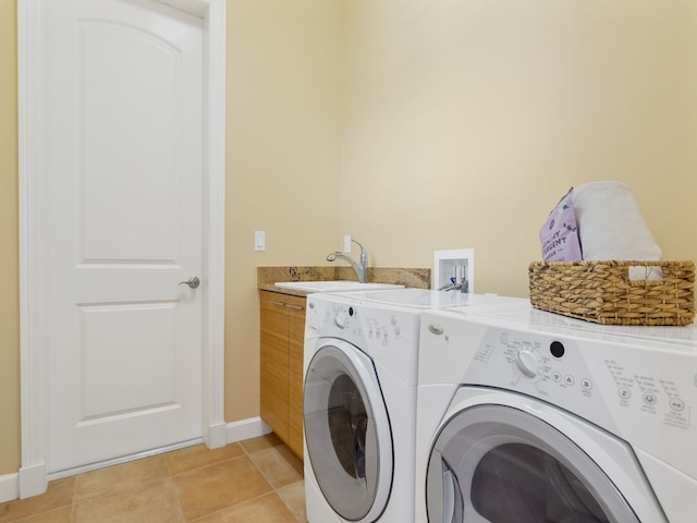 clothes washing area with washing machine and dryer, cabinets, sink, and light tile patterned floors