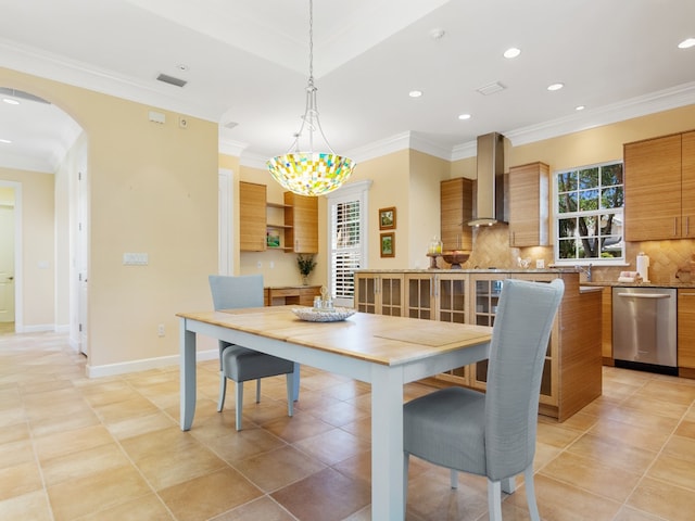 dining area with ornamental molding and light tile patterned flooring