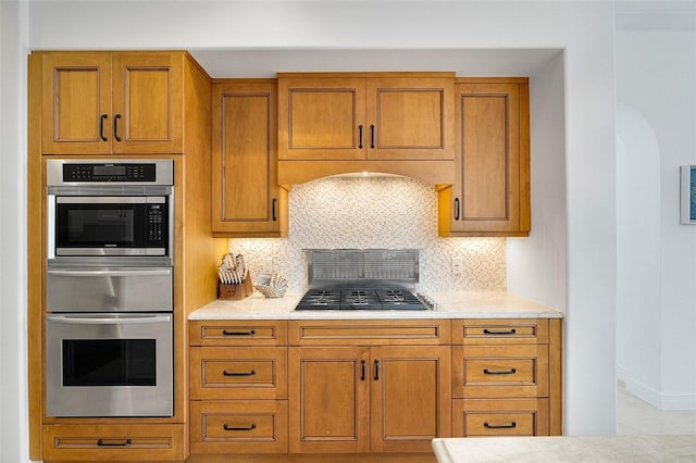 kitchen featuring decorative backsplash and stainless steel appliances