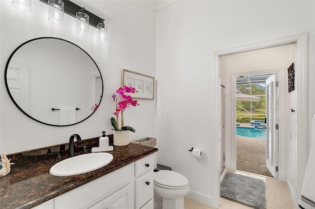 bathroom with walk in shower, vanity, toilet, and tile patterned flooring