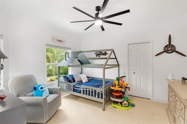 bedroom with light carpet, ornamental molding, and ceiling fan