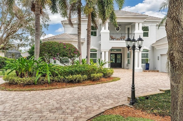 view of front of house with french doors and a balcony