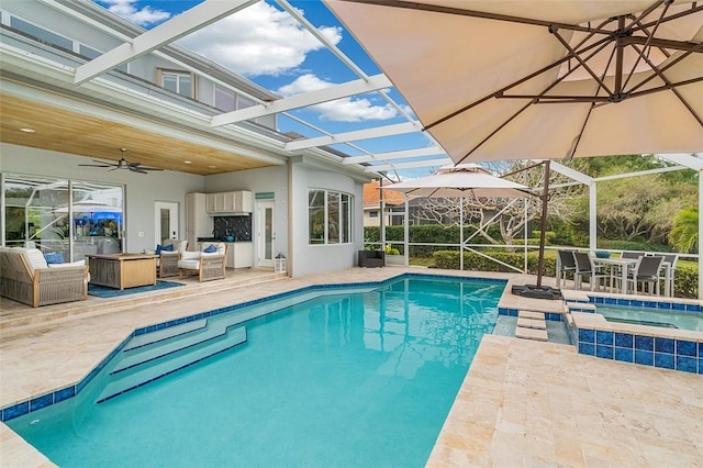 view of swimming pool with a patio, an in ground hot tub, a lanai, ceiling fan, and an outdoor living space