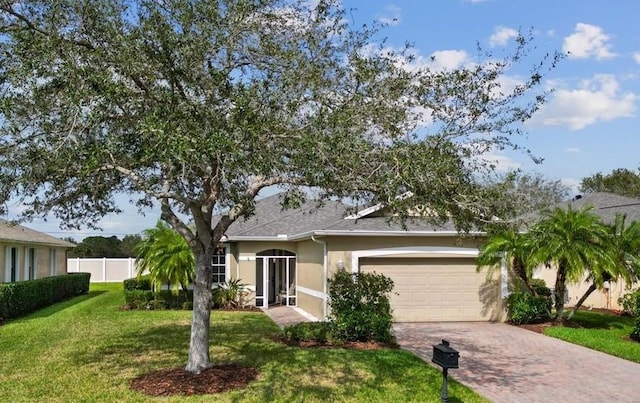 view of front of property with a garage and a front yard