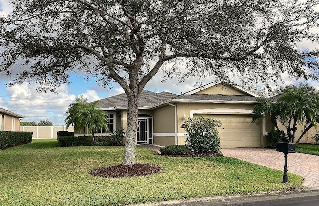 ranch-style home featuring a garage and a front lawn