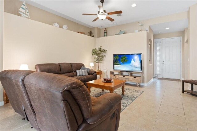 tiled living room with ceiling fan