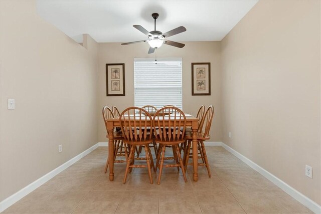 dining area with light tile patterned flooring and ceiling fan