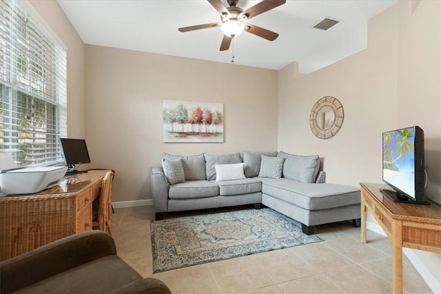 living room featuring light tile patterned flooring and ceiling fan