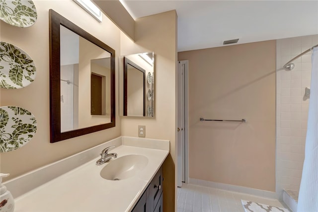 bathroom with a shower with shower curtain, vanity, and tile patterned floors