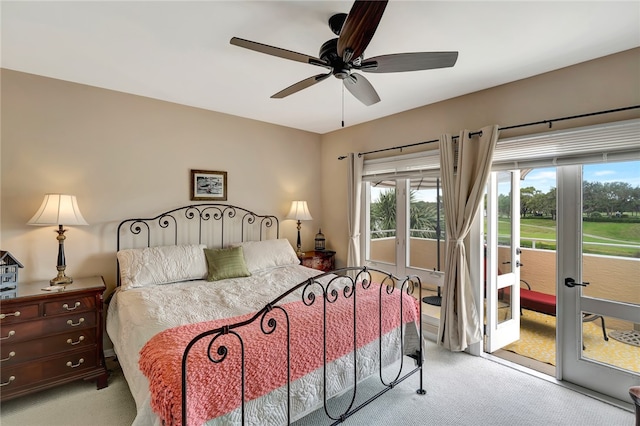 bedroom with ceiling fan, multiple windows, and access to outside