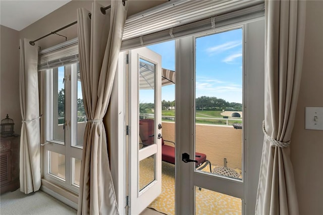 5075 Harmony Cir Unit 302, Vero Beach, FL 32967 - doorway to outside featuring plenty of natural light and carpet