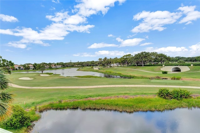 view of property's community featuring a water view and a yard