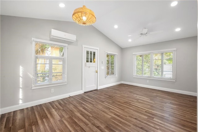 foyer entrance with dark wood-type flooring, a wall unit AC, ceiling fan, and lofted ceiling