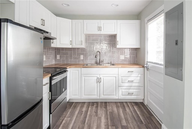 kitchen with wooden counters, appliances with stainless steel finishes, sink, and white cabinets