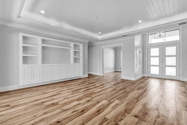 unfurnished living room featuring crown molding, wood ceiling, light hardwood / wood-style flooring, and french doors