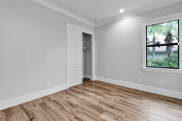 unfurnished bedroom featuring crown molding and light hardwood / wood-style floors