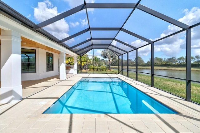 view of swimming pool with a patio, a water view, and a lanai