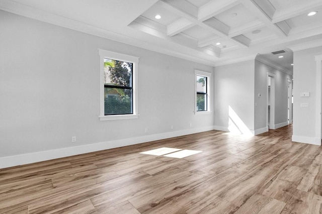 empty room with beamed ceiling, plenty of natural light, coffered ceiling, and light wood-type flooring