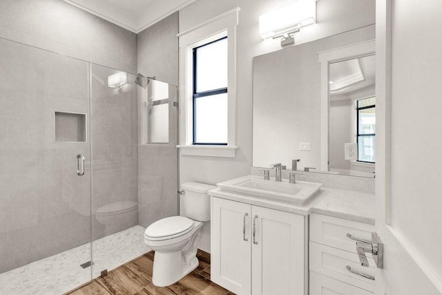 bathroom featuring hardwood / wood-style flooring, a healthy amount of sunlight, toilet, and an enclosed shower