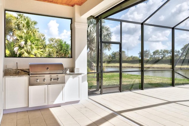 unfurnished sunroom with sink, plenty of natural light, and a water view