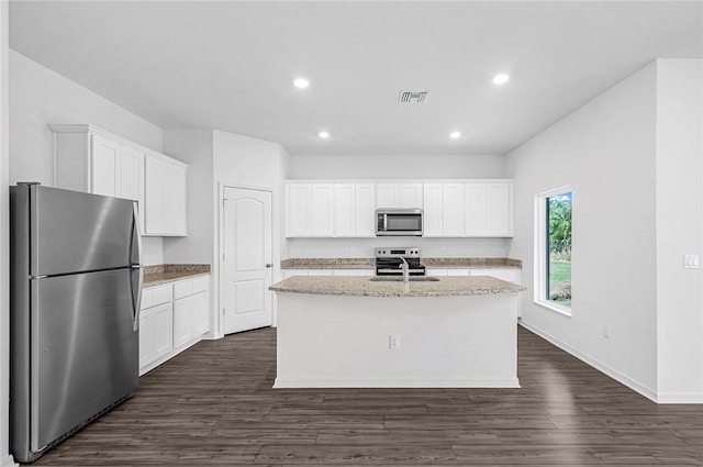7986 104th Ct, Vero Beach, FL 32967 - kitchen featuring appliances with stainless steel finishes, dark wood-style floors, a kitchen island with sink, white cabinetry, and recessed lighting