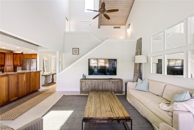 living room with high vaulted ceiling and ceiling fan