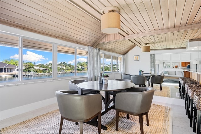 dining space featuring wood ceiling, light tile patterned floors, a water view, and vaulted ceiling with beams