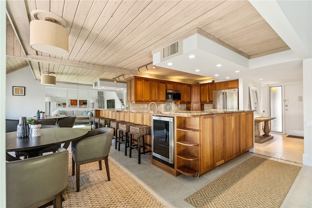 kitchen with stainless steel appliances, wooden ceiling, wine cooler, kitchen peninsula, and light tile patterned floors