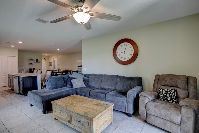 living room with ceiling fan, light tile patterned floors, and sink