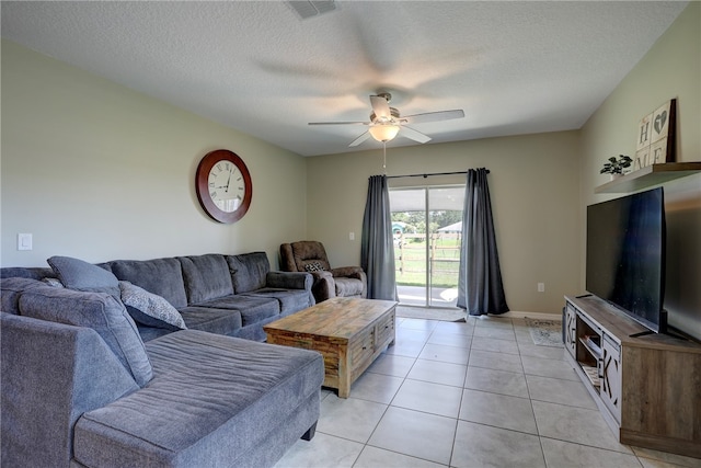 tiled living room with a textured ceiling and ceiling fan