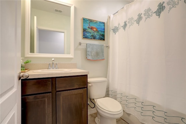 bathroom featuring toilet, vanity, a shower with shower curtain, and tile patterned flooring