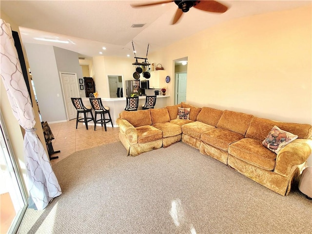 living room with light tile patterned flooring, lofted ceiling, and ceiling fan