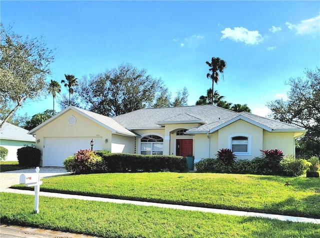 ranch-style home featuring a garage and a front lawn