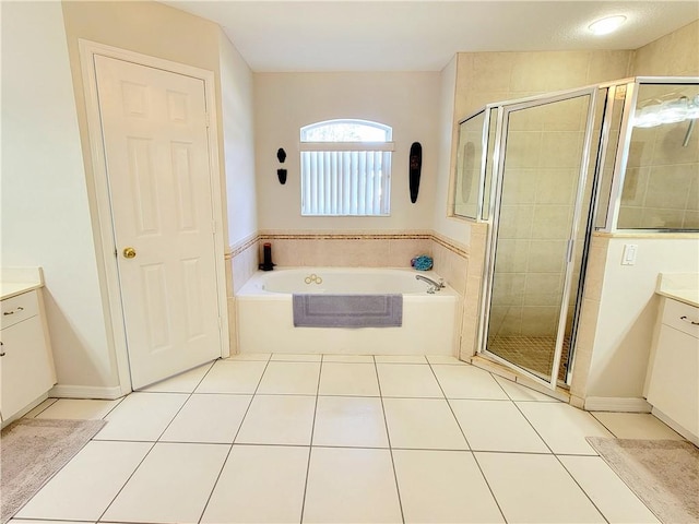 bathroom with tile patterned floors, separate shower and tub, and vanity