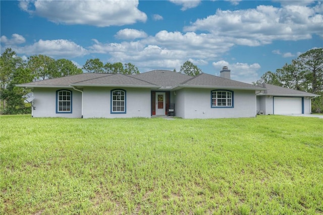 ranch-style home featuring a garage and a front lawn